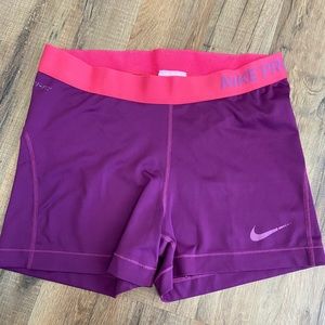 Large purple and pink Nike Pro spandex shorts
